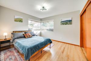 a bedroom with a bed and a window at Quaint Renton Home about 15 Mi to Downtown Seattle! in Renton