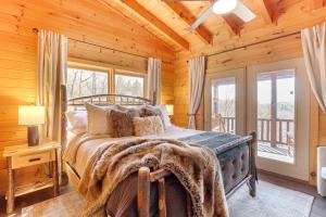 a bedroom with a bed in a log cabin at Kid-Friendly Morganton Gem 10 Mi to Blue Ridge! in Morganton