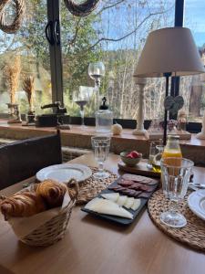 a table with a basket of food and a window at La Lolita ( Adults Only ) in Sant Martí Vell