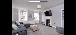 a living room with a couch and a fireplace at Apartment in Scottish Borders in Jedburgh