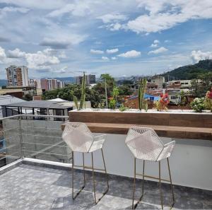 two chairs sitting on top of a balcony at Hotel Terraza in Floridablanca