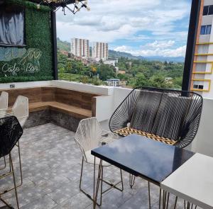 a patio with two chairs and a table on a balcony at Hotel Terraza in Floridablanca