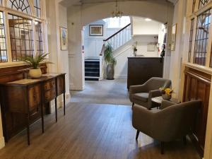 a hallway with chairs and a desk in a house at The National Hotel in Dingwall