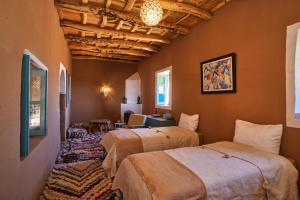 a bedroom with two beds in a room at Agafay Desert Hotel in El Karia
