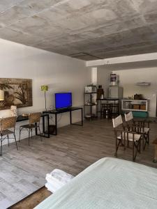 a bedroom with a bed and a table and chairs at Delta Center , loft 51 ms , frente a Nordelta. in Benavídez