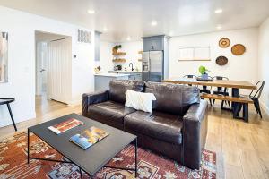 a living room with a leather couch and a table at Near Downtown Stylish 2BR With Amazing Patio - 5 in Moab