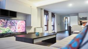 a living room with a large flat screen tv at Apartamento rural Castillo de Yeste 2 pax in Yeste