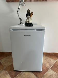 a lamp sitting on top of a white refrigerator at Hostal La Campiña in Ronda