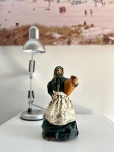 a figurine of a woman standing next to a lamp at Hostal La Campiña in Ronda