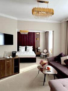 a living room with a bed and a couch at Hotel 5 Continents in Craiova