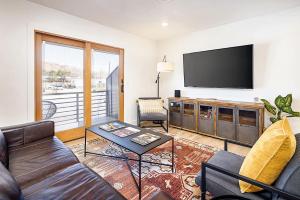 a living room with a couch and a flat screen tv at Near Downtown Stylish 2BR With Amazing Patio - 4 in Moab