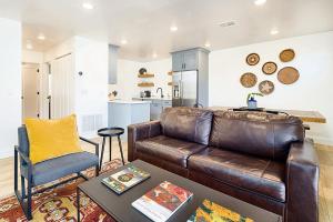 a living room with a leather couch and a table at Near Downtown Stylish 2BR With Amazing Patio - 4 in Moab