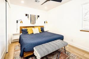 a bedroom with a bed with blue sheets and yellow pillows at Near Downtown Stylish 2BR With Amazing Patio - 4 in Moab