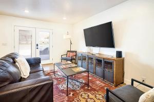 a living room with a couch and a flat screen tv at Near Downtown Stylish 2BR With Amazing Patio - 3 in Moab