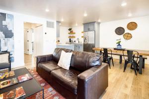 a living room with a leather couch and a table at Near Downtown Stylish 2BR With Amazing Patio - 3 in Moab