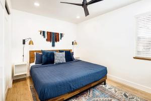 a bedroom with a blue bed and a ceiling fan at Near Downtown Stylish 2BR With Amazing Patio - 3 in Moab