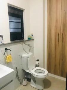 a bathroom with a white toilet and a sink at Luxurious Lifestyle in Cape Town +6 photos