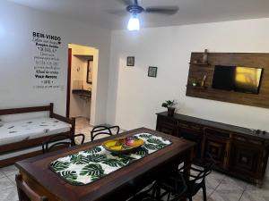 a room with a table with a bowl of fruit on it at Apartamento Mar Brasil II in Ubatuba