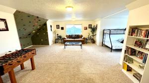a living room with a rock climbing wall at Sleeps 20! Rare Family Friendly House. in Payson