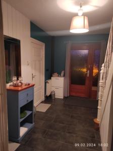cocina con paredes azules, puerta y suelo en Nicki's Ferien Oase en Bornhöved