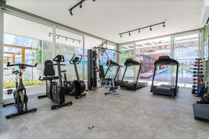 a gym with a bunch of treadms and cardio machines at Studio em Home Club Resort frente mar SHR103 in Florianópolis