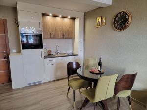 a kitchen and dining room with a table and chairs at Apartman 310 in Zlatibor