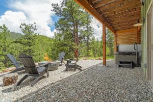 a patio with chairs and a grill next to a house at Valley Vista Lodge Hot Tub Shuffleboard Darts BBQ in Midland