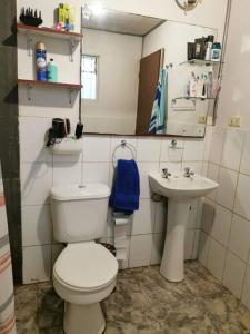 a small bathroom with a toilet and a sink at Alojamiento Casa completa en Puerto Montt in Puerto Montt