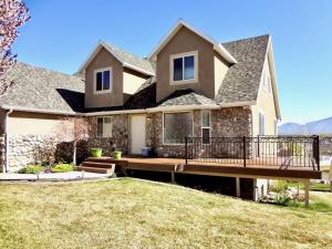 a house with a deck and a yard at Sleeps 20! Rare Family Friendly House. in Payson