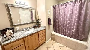 a bathroom with a sink and a shower at Sleeps 20! Rare Family Friendly House. in Payson +46 photos