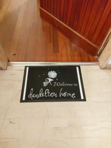 a welcome mat on the floor of a room at Dandelion home Viareggio centro in Viareggio