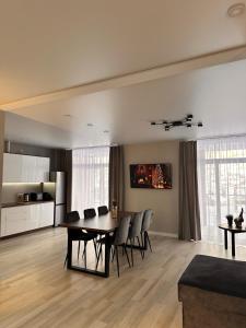 a dining room and kitchen with a table and chairs at Park House in Palyanytsya
