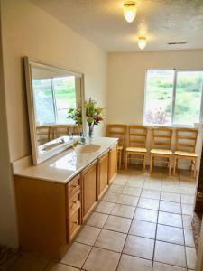 a bathroom with a sink and a mirror at Sleeps 20! Rare Family Friendly House. in Payson