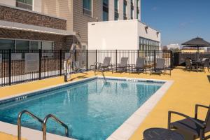 a swimming pool on a building with chairs at Fairfield by Marriott Inn & Suites Huntsville Redstone Gateway in Huntsville