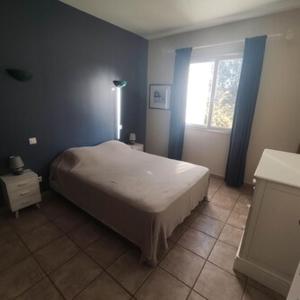 a bedroom with a large bed and a window at Villa Sant Antone in Ghisonaccia +6 photos