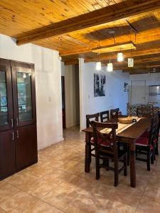 a dining room with a wooden table and chairs at Lothbrok House in Villa Rumipal