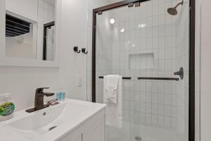 コロンバスにあるHousepitality - The City View Suiteのシャワーと洗面台を備えた白いバスルーム +28枚の写真