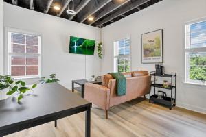 uma sala de estar com um sofá e uma mesa em Housepitality - The City View Suite em Columbus