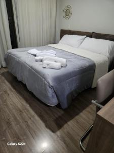 1 dormitorio con 1 cama con toallas en Suíte Barra Olimpica/Rio Centro/Jeunesse Arena., en Río de Janeiro