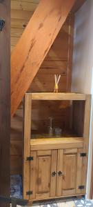 a wooden cabinet with a sink in a room at Tiny House Novas Palmeiras in Florianópolis