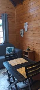 a living room with a table and a couch at Tiny House Novas Palmeiras in Florianópolis