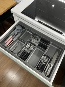 a drawer filled with utensils in a kitchen at EightApartament in Bistriţa