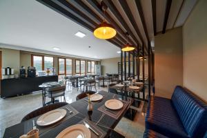 a dining room with tables and chairs and windows at Rest by Dedeman Karabük in Karabük