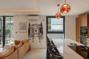 a kitchen and living room with a table and chairs at Four The Reach in Salcombe