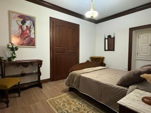 Casa de São Braz في Landim: غرفة نوم بسرير وطاولة وباب