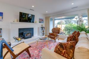 a living room with a couch and a fireplace at Greenbrae Garden Cottage Near Beaches and Redwoods in Green Brae