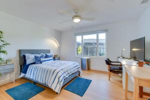 a bedroom with a bed with blue rugs and a desk at Greenbrae Garden Cottage Near Beaches and Redwoods in Green Brae
