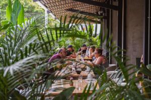 a group of people sitting at a table at Eutopiq Hotel in Medellín
