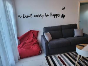 a living room with a couch and a red pillow at appartement cosy in Tafers