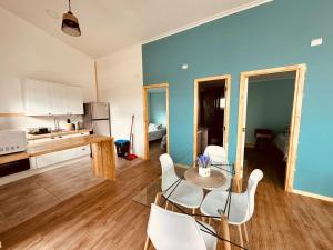 a kitchen and dining room with a table and chairs at Cabañas Arte Brisa Patagonia in Puerto Natales